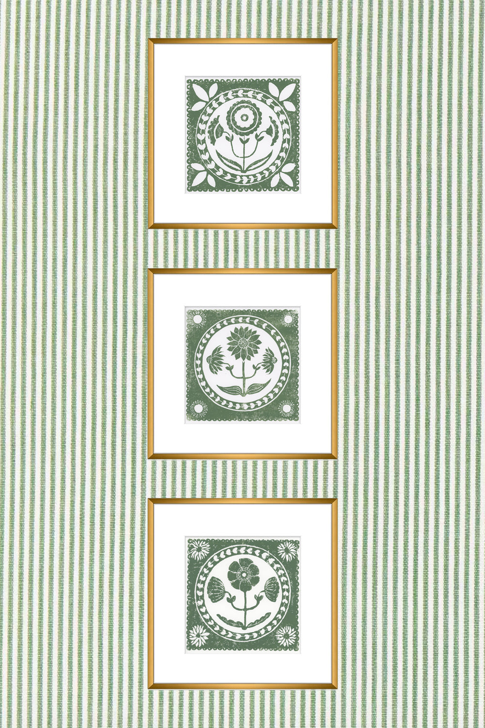 Three framed artworks with green patterns on a striped green and white wall.