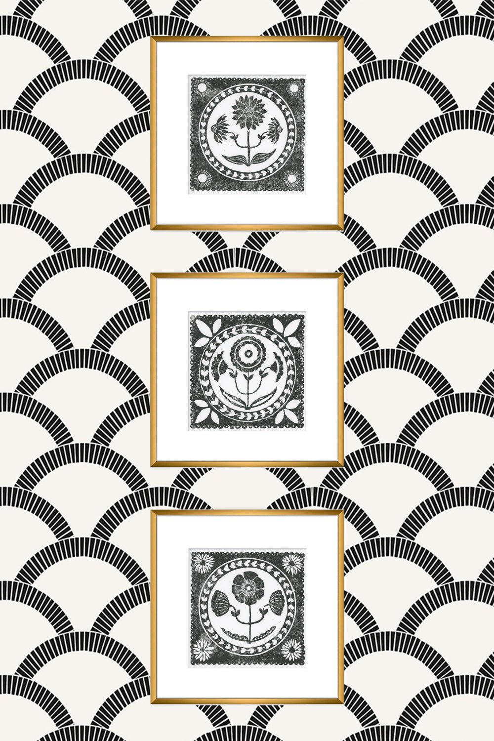 Three framed black and white prints on a patterned wall