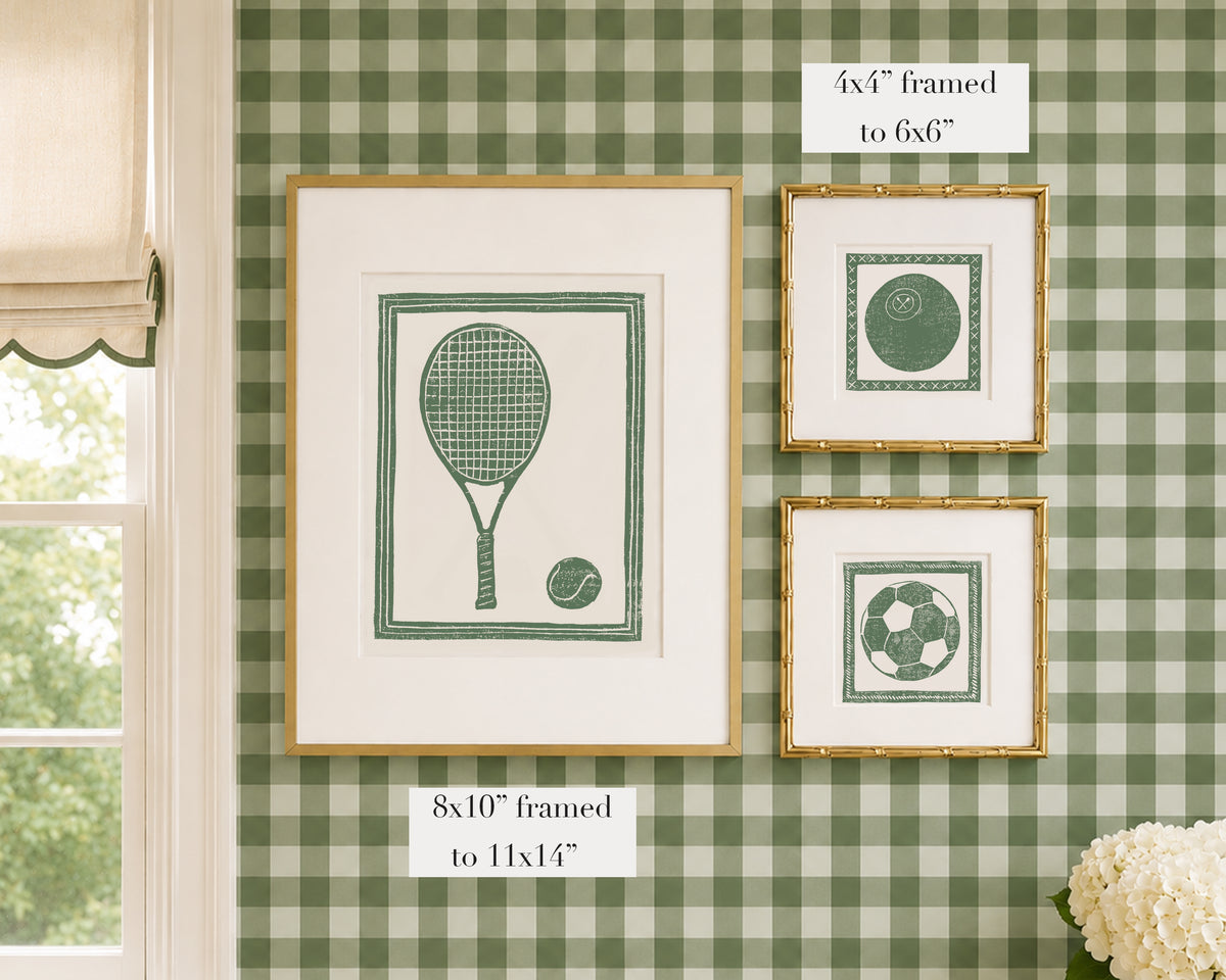 Framed grass green and white sports themed artwork on a green gingham wallpapered wall with window and floral decor.