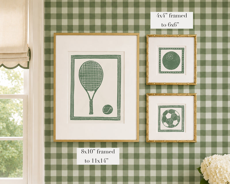 Framed grass green and white sports themed artwork on a green gingham wallpapered wall with window and floral decor.