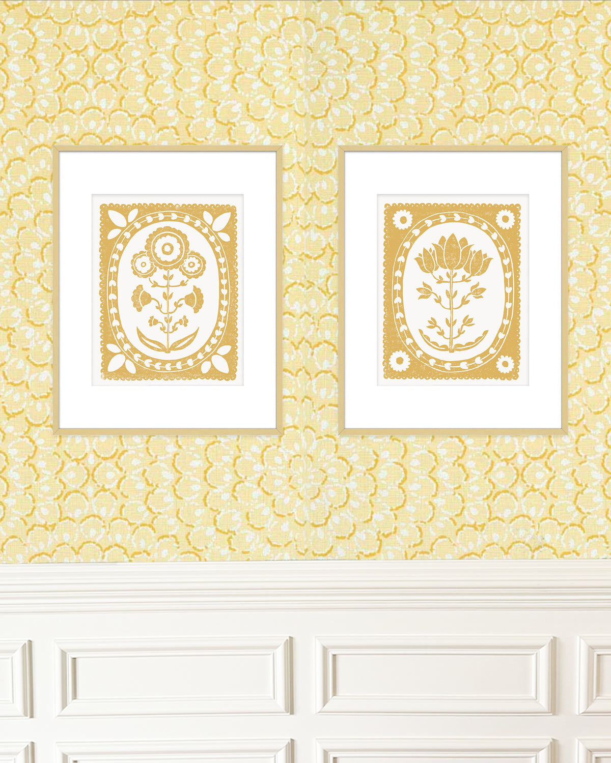 Two framed artworks with floral patterns on a yellow patterned wall.