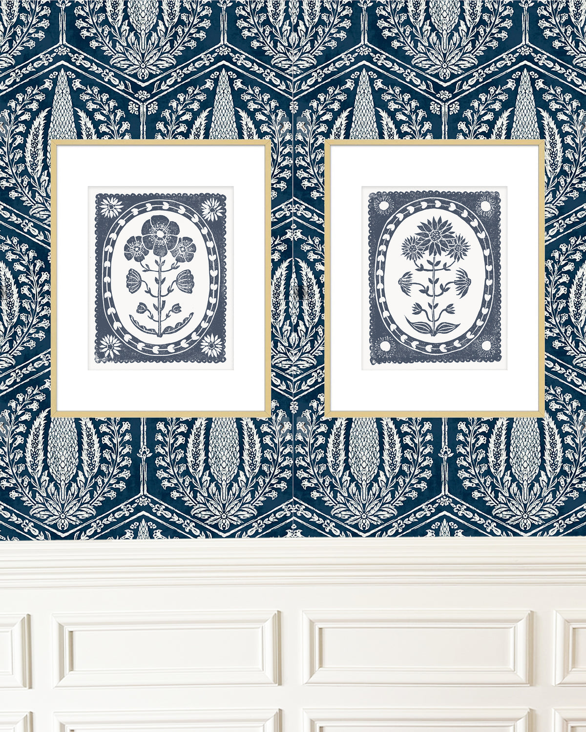 Two framed artworks with floral designs on a navy blue and white patterned wall.