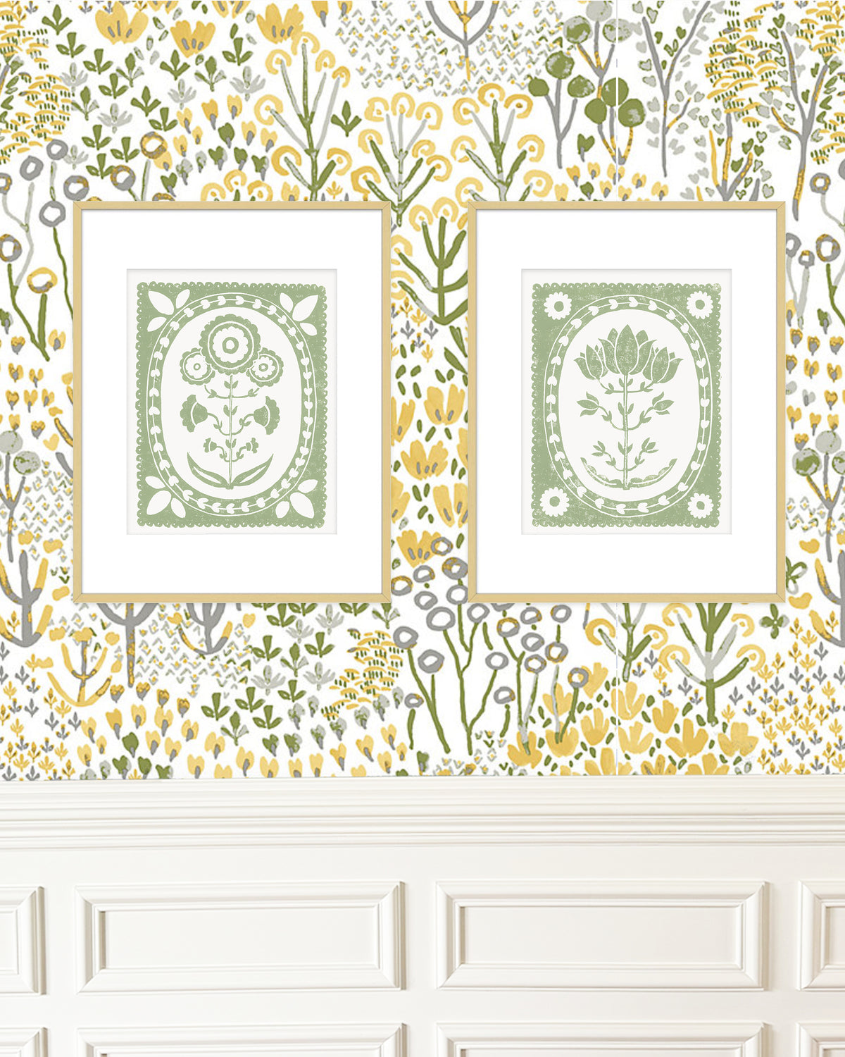 Two framed botanical prints on a decorative wall with floral patterns.