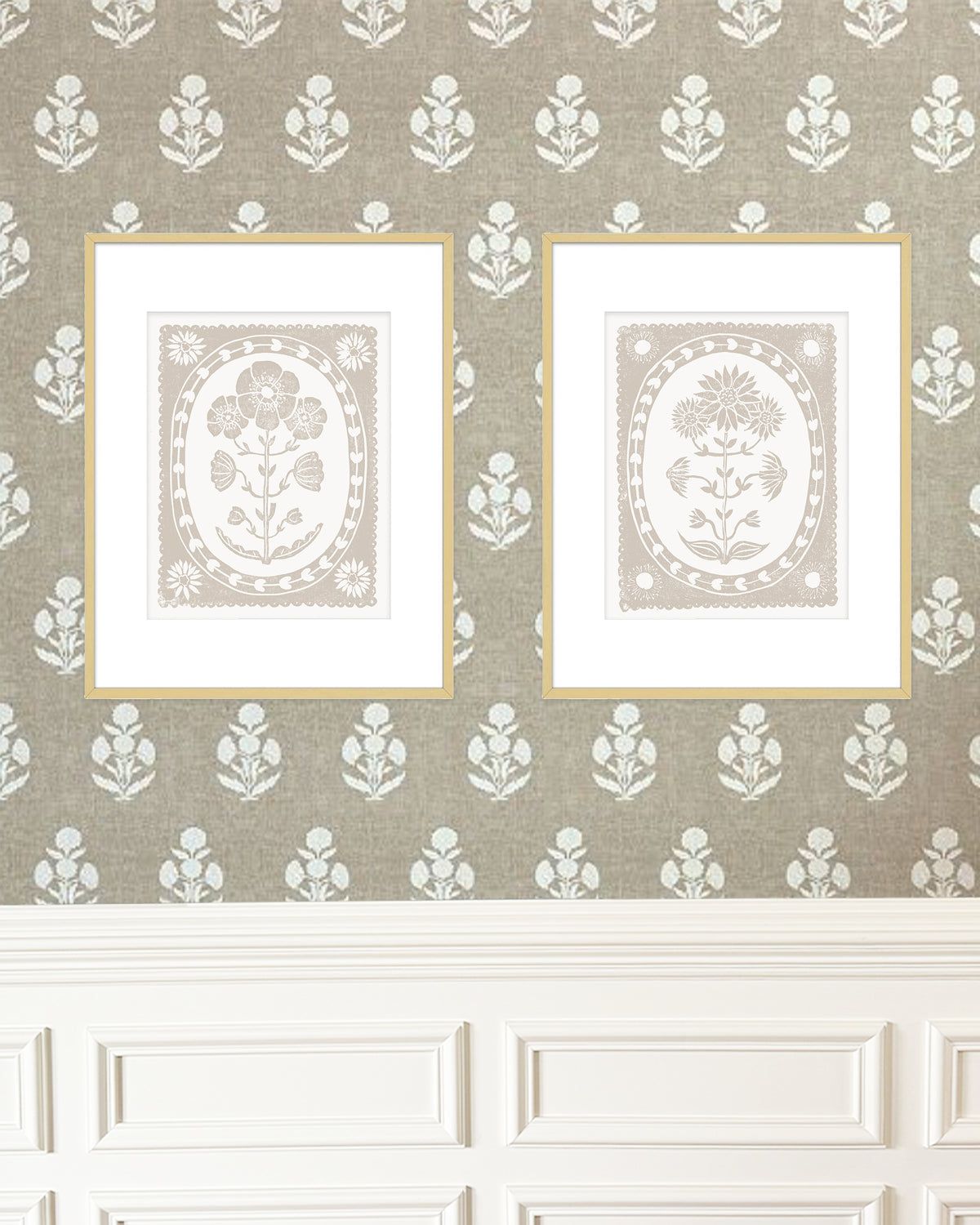 Two framed artworks on a wall with decorative wallpaper