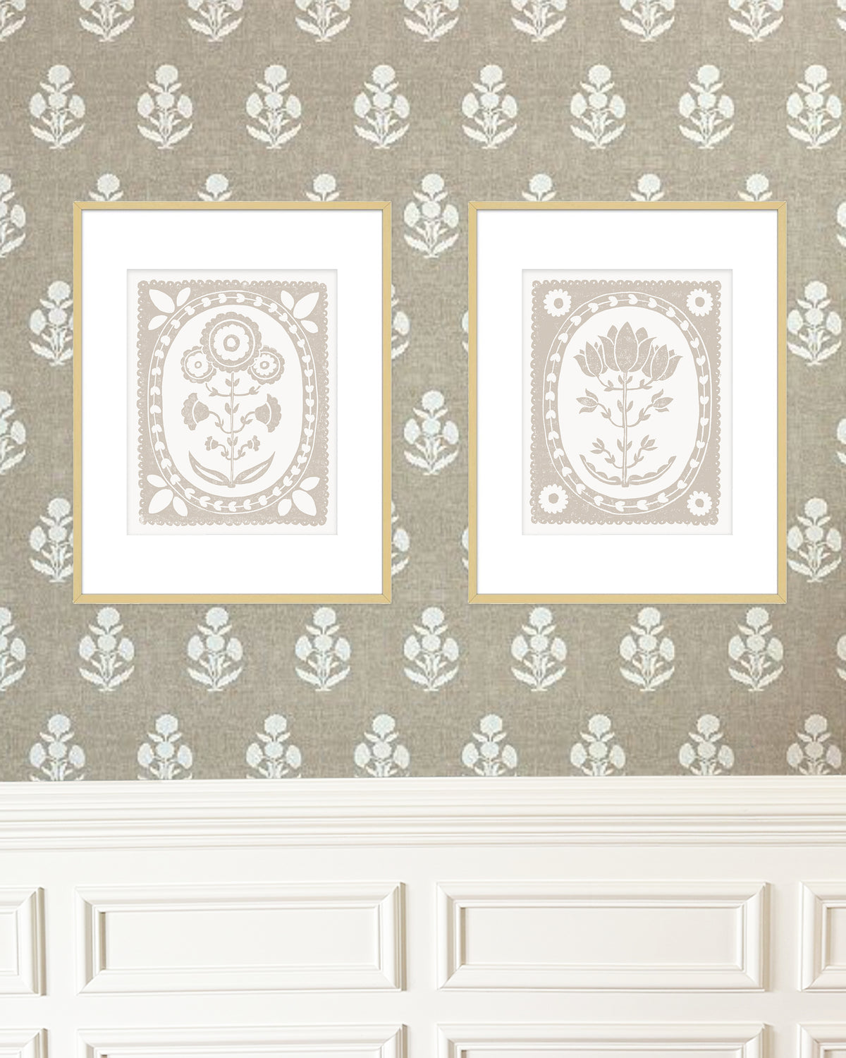 Two framed artworks on a decorative wall with floral patterns