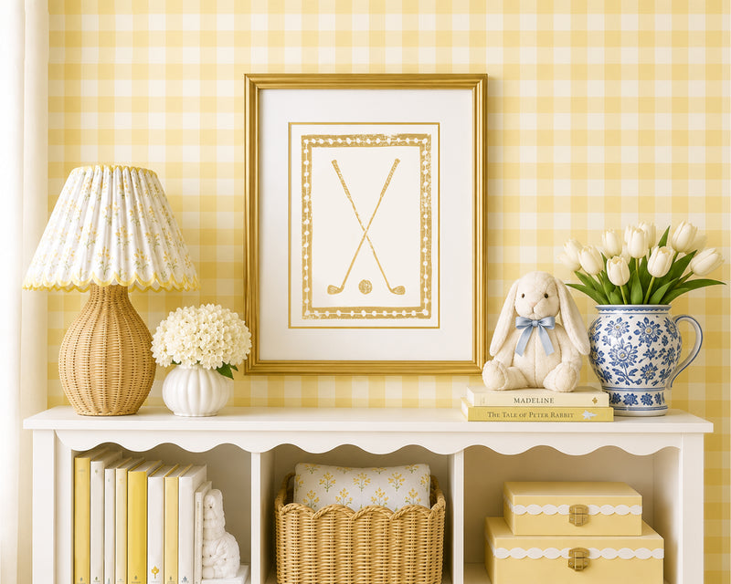 Framed mustard yellow golf clubs in a styled yellow and white bedroom