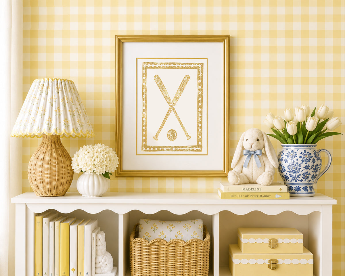 Decorative interior with a lamp, framed picture, and decorative items on a console table against a yellow checkered wall.