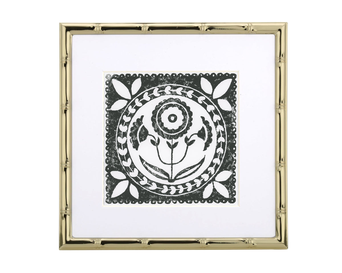 Decorative black and white design in a gold frame on a white background
