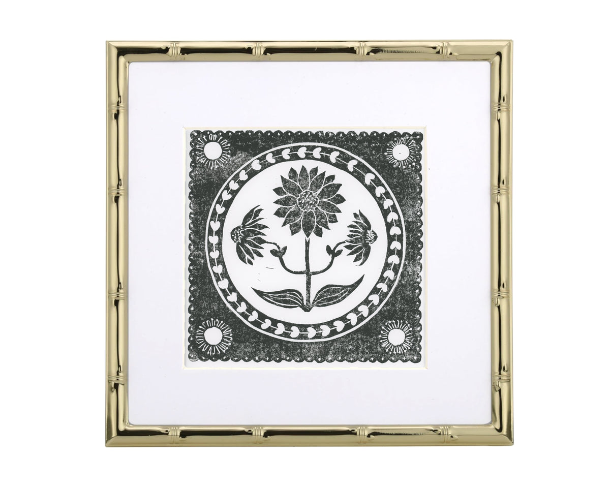 Decorative wall art with floral design and gold frame on white background