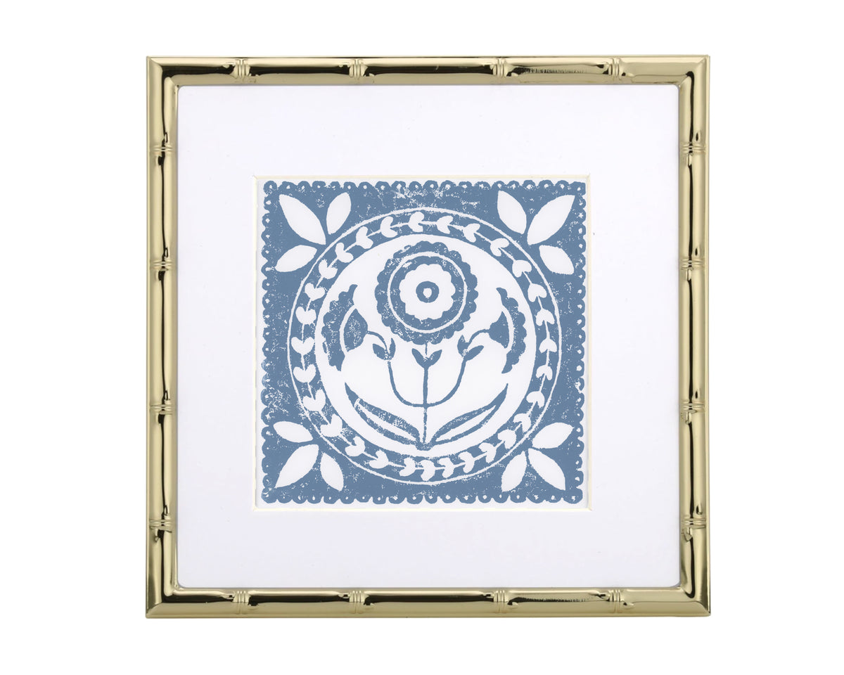 Decorative print with a blue floral design in a gold frame on a white background