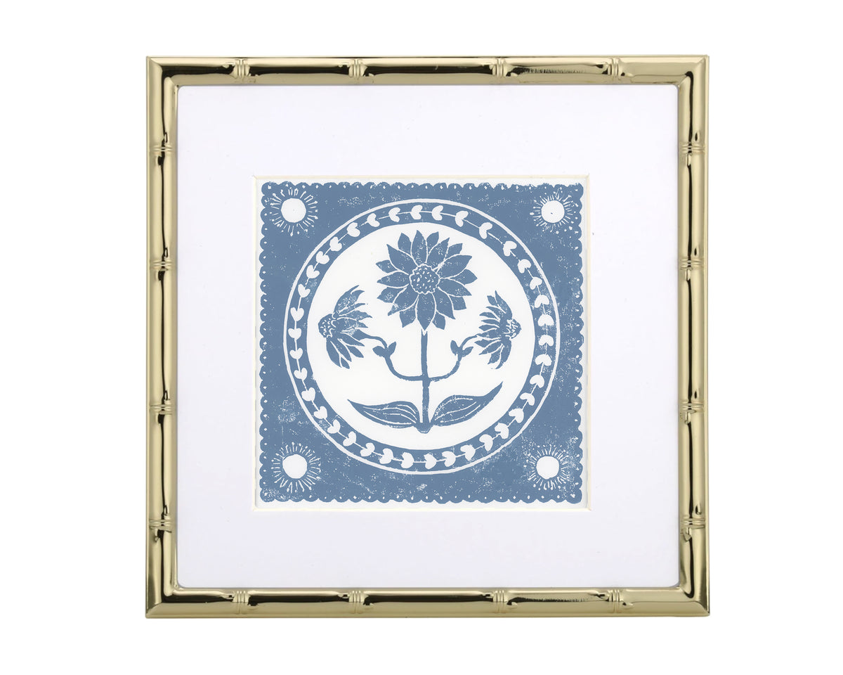 Decorative print with floral design in a gold frame on a white background