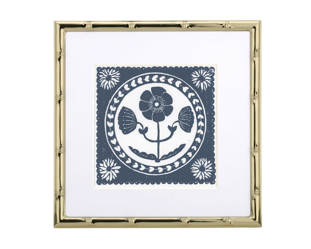 a blue and white floral design in a gold frame