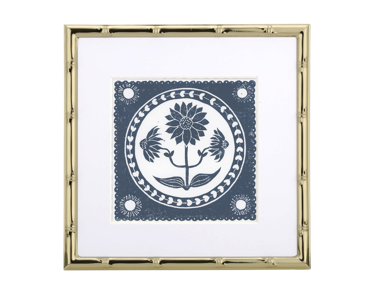 Decorative print with floral design in a gold frame on a white background