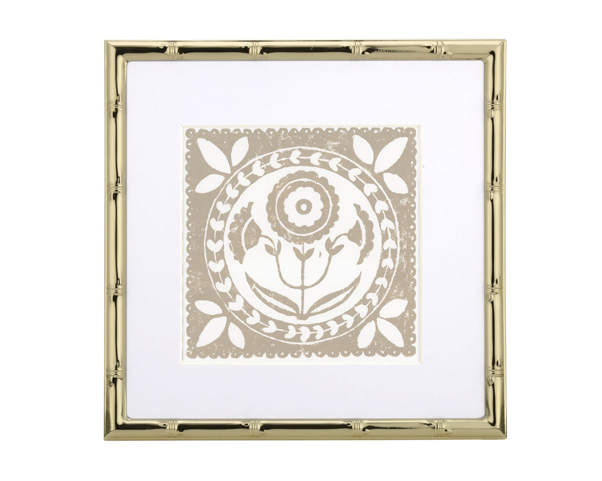 Decorative wall art with a gold frame and white design on a white background